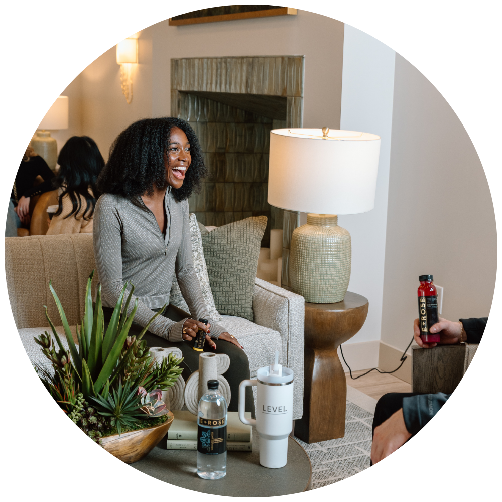 Woman sitting in Level lounge laughing