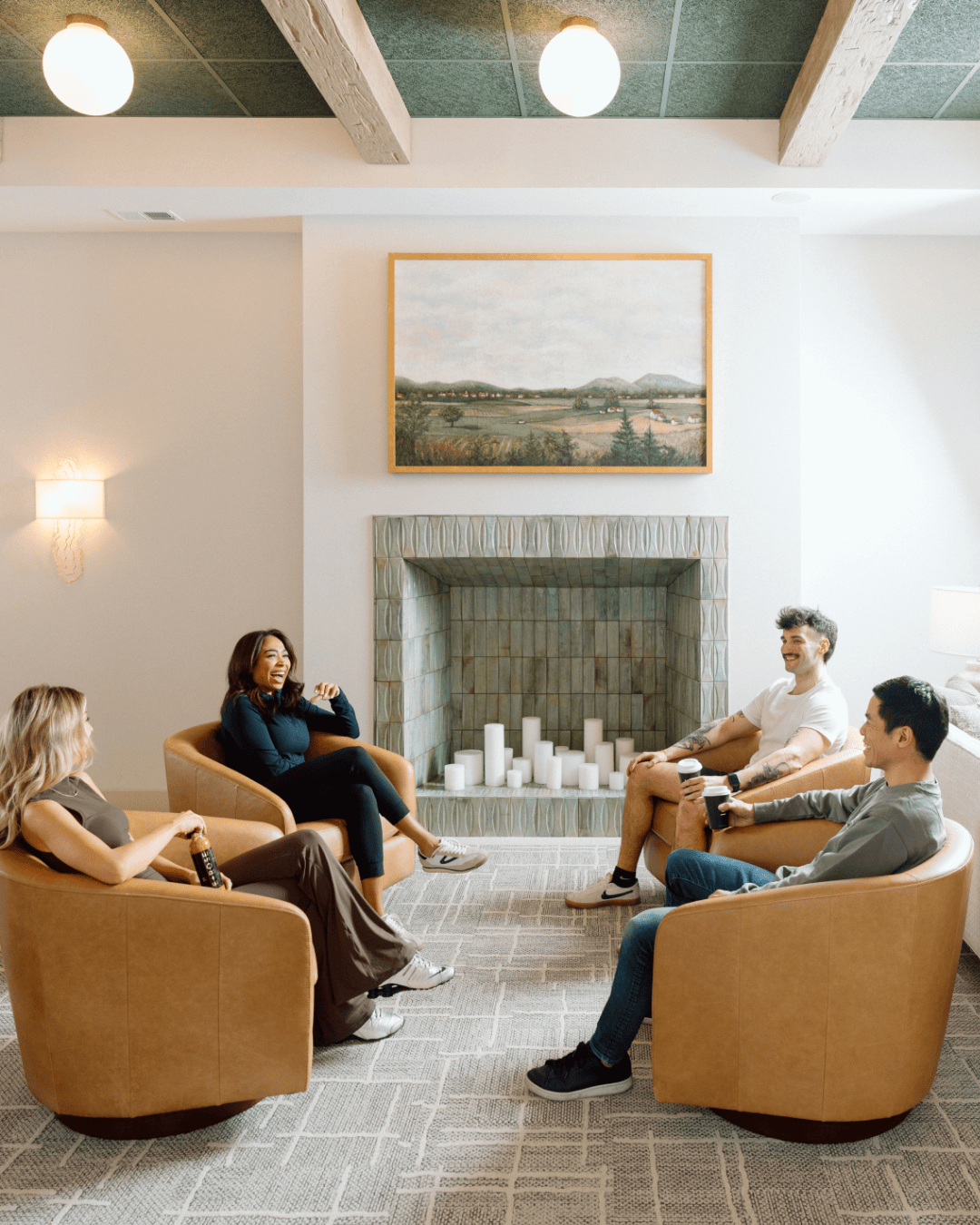 Level About Us - four people chatting in the Level lobby