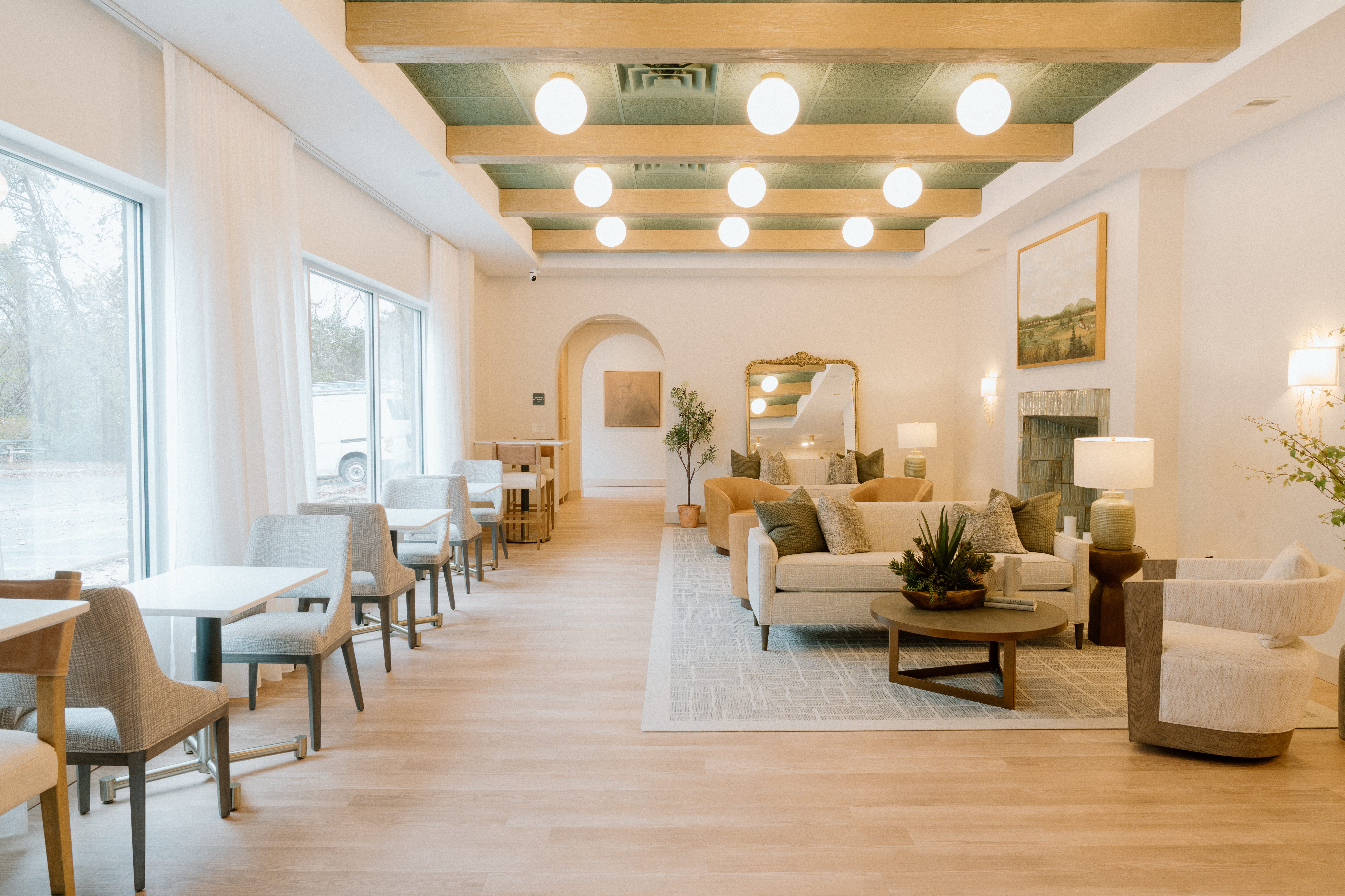 Comfy lounge-style lobby in natural tones of green, tan, and cream.