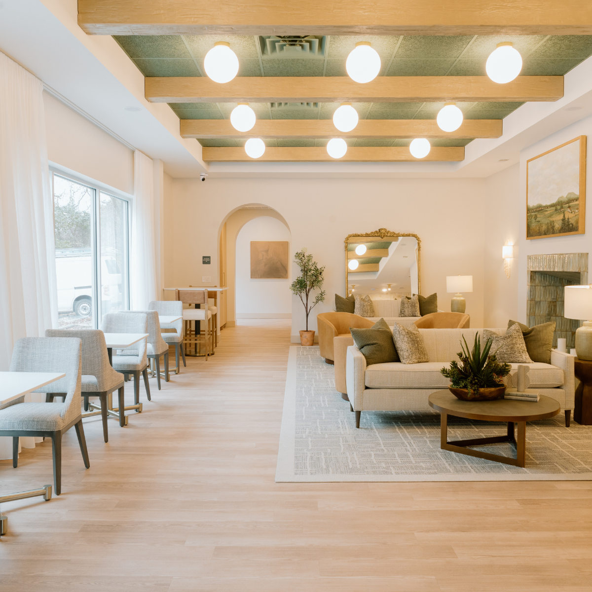 Comfy lounge-style lobby in natural tones of green, tan, and cream.