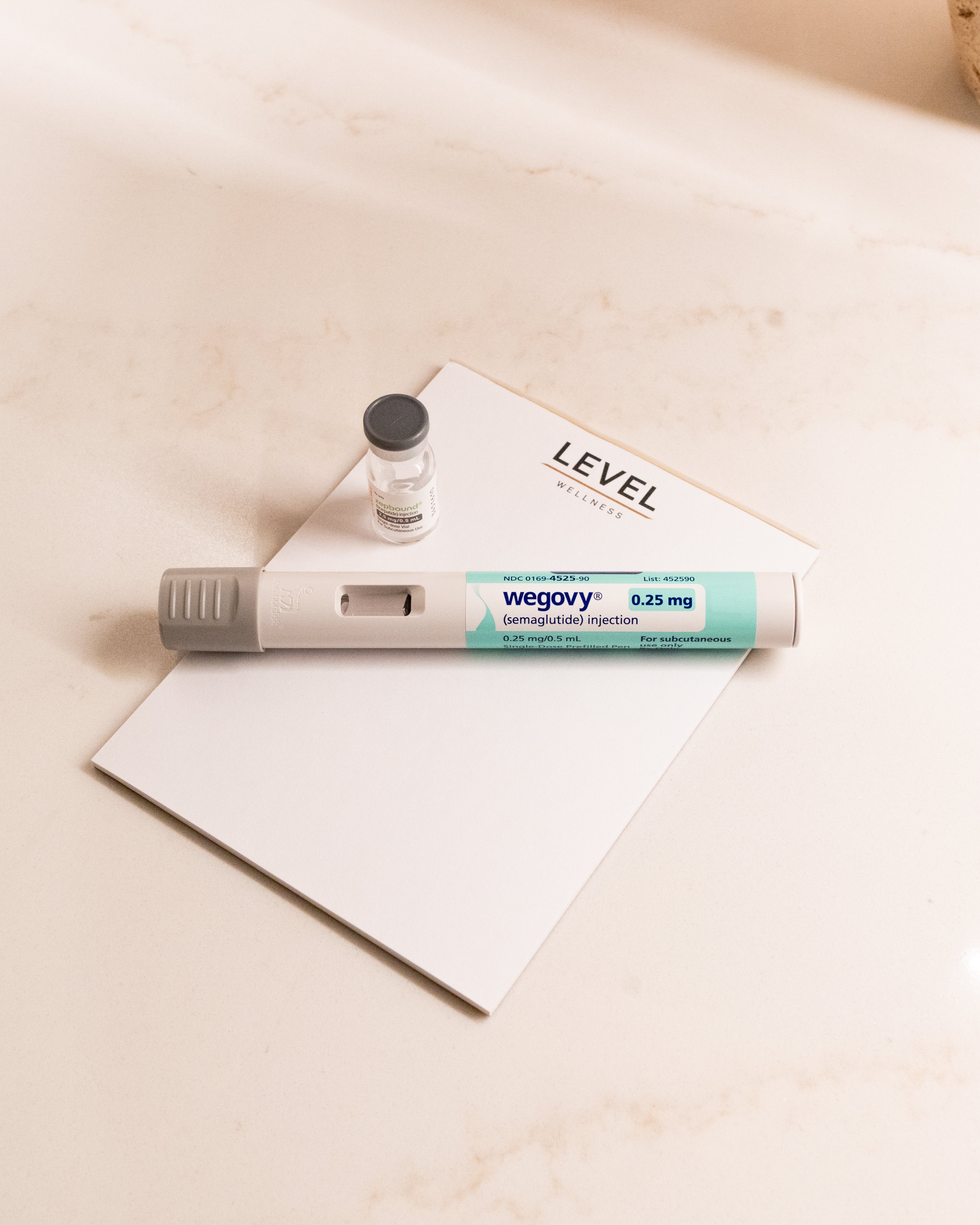 Wegovy GLP-1 Pen on top of Level notepad.